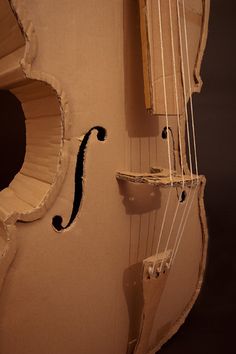 an old violin is sitting on display in a museum case, with the strings still attached to it