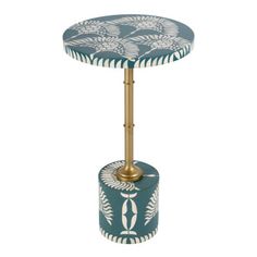 a table with a blue and white design on the top, it has a gold metal base