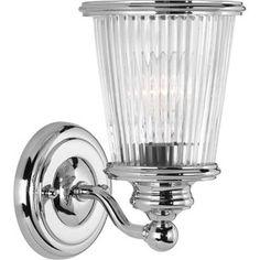 a chrome wall light with clear glass shades