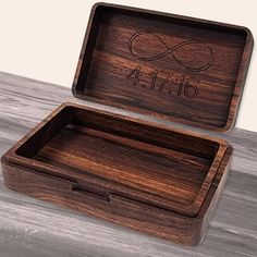 a wooden box with the date and time engraved on it, sitting on a table