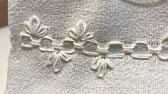 an embroidered piece of cloth with flowers on it