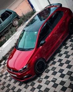 a red car is parked on the street