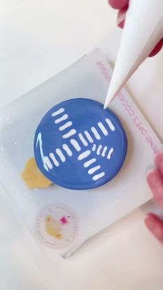 a person is using a toothbrush to brush the teeth on a blue object with white tips