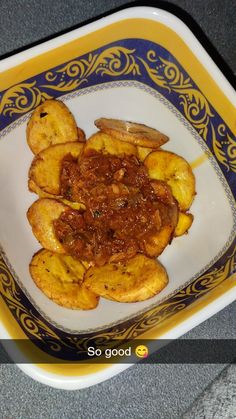 some food is on a yellow and blue plate