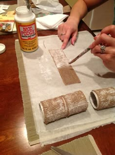 two women are making decorative items on a table