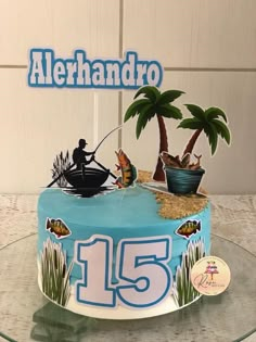 a birthday cake decorated with an image of a man fishing on the lake and palm trees