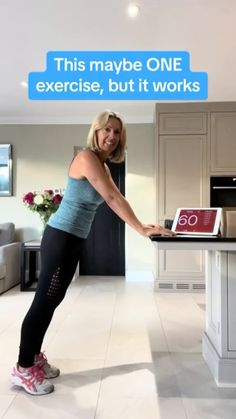 a woman standing in front of a laptop computer