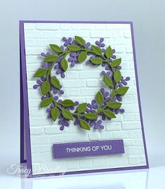 a handmade card with purple flowers and green leaves on it, which reads thinking of you