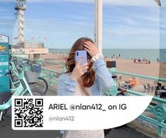 a woman taking a selfie on the beach with seagulls in the background