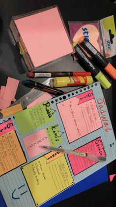 a binder with sticky notes, pens and markers