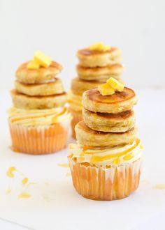 three cupcakes are stacked on top of each other and topped with lemon zest