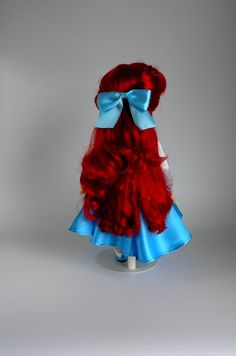 a doll with red hair and blue dress