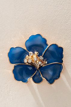 Forever timeless in a femme, floral design, this stand-out brooch is featured in a hibiscus-inspired silhouette with rhinestone detailing at center for a stunning finishing touch. | Holiday Hibiscus Brooch by Free People in Blue Wedding 2024, Flower Brooch, Boho Clothing, Jewelry Branding, Blue Flowers, Hibiscus, Floral Design, Free People, Floral