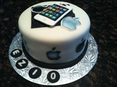 a white cake with an ipod on top and some black numbers around the edges,