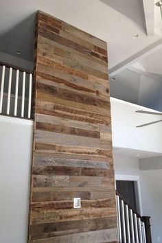 a tall wooden pillar sitting in the middle of a room