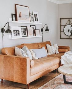 a living room filled with furniture and pictures on the wall