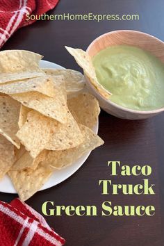 a white plate topped with tortilla chips next to a bowl of guacamole