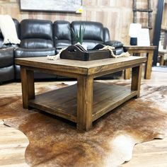 a coffee table sitting on top of a cowhide rug