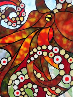 an octopus is depicted in this colorful stained glass art piece, with circles and dots all over it