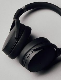 black headphones sitting on top of each other