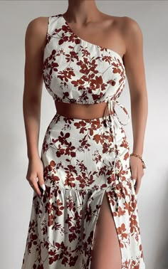 Bring back the beautiful bohemian spirit in the Meghan One Shoulder Two Piece Set featuring shadow florals in a rusty brown shade. This gorgeous ensemble consists of a cropped top shaped with a sweet one shoulder neckline and cinched with lace ties that drape on one side. Meanwhile the coordinating maxi skirt is shaped to a high rise waist then falls into a voluminous A-line silhouette with a trio of tiers finished with a sultry high leg split. Dress it down with flat sandals and a canvas tote b Set Outfits, Classy Dress, Two Piece Dress, Two Piece Set, Metropolis