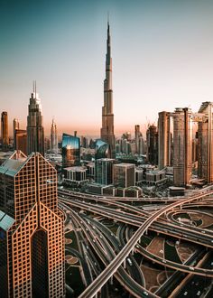 an aerial view of a large city with tall buildings and roads in the foreground