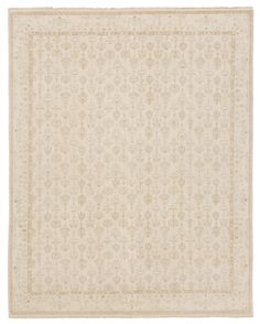 a white rug with an intricate design on the top and bottom, it has a beige border