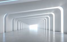 an empty white room with light coming through the ceiling and lighting up the walls in the center