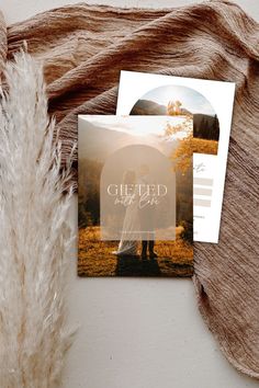 a couple standing under an umbrella on top of a blanket next to a card with the words, guided by god