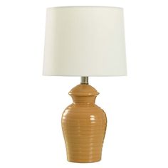 a brown ceramic lamp with a white shade