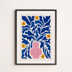 a pink vase with yellow flowers on a blue and white background is framed in black