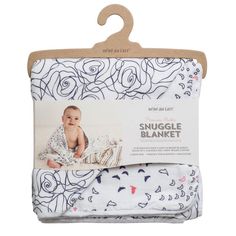 the snuggle blanket in white with blue and pink flowers on it, is packaged for