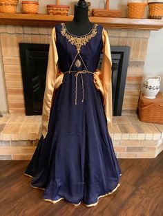 "This is a designer Renaissance dress in navy blue and gold.  Dress zips up side.  Chest is heavily hand embroidered.  Tie on bussel.  Sleeves drape with navy embroidery at shoulders.  Medallion in middle of chest with cording.  Chest 40\", waist 32\", length 54\". You will never see another like this." Royal Fitted Dress With Resham Embroidery, Navy Blue And Gold Dress, Fem Clothing, Historic Dresses, Historical Outfits, Blue And Gold Dress, Fair Outfit, Medieval Dresses, Navy Embroidery