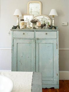 an old blue cabinet in the corner of a room