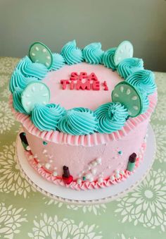 a pink and blue cake sitting on top of a table