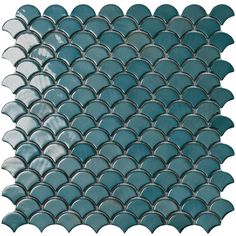 the back side of a blue mosaic tile with scalloped shapes on white background