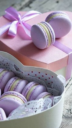 macaroons are in a pink box on the table