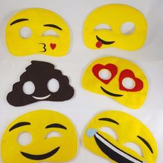 six different emoticive smiley face masks on a white surface