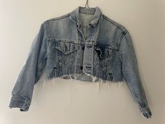 "Authentic 80s 90s Levis blue jean jacket thats been cropped, super cute short fit 100% cotton  Made in USA  Measurements taken flat double when necessary  Shoulder to shoulder 17.5\" Pit to pit 19\" Sleeve length 18\" Shoulder to hem 12.5\" Due to the nature of vintage, all items in my store are sold as is. All sales are final without exception, I have a no returns/refunds policy. However, please contact me if there is a problem with your order. Please refer to the FAQs at the bottom of the pag Cropped Light Wash Denim Jacket, Vintage Ripped Denim Jacket For Spring, Light Wash Distressed Denim Jacket For Summer, Fitted Distressed Denim Jacket For Summer, Casual Denim Jacket With Frayed Hem For Festivals, Spring Grunge Denim Jacket With Frayed Hem, Edgy Cropped Denim Jacket For Spring, Fitted Light Wash Cropped Denim Jacket, Fitted Cropped Light Wash Denim Jacket