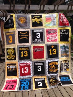 a quilt made to look like it has numbers on it and is sitting on a wooden deck