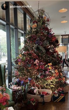 a christmas tree is decorated with colorful flowers