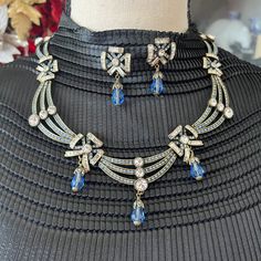 Hdj4014: Heidi Daus Choker Style Necklace. Curved Double Bar With Graduated White Crystal On Each Bar. Next Link Has Blue And While Multi Shaped Faceted Crystals. Next Link Has Three Bars With Graduate White Crystal On Each Bar. Following Three Links Continues The Sequence And These Three Links Also Has A Blue Briolette Drop From The Bottom Of The Link. Matching Earrings That Have The Multi Shaped Beads And A Blue Briolette Drop From The Bottom Of The Earring. For Pierced Ears Only. Necklace Can Be Worn As A 16" Choker Or Longer With The 4" Extender. Colors Of The Stones Are Periwinkle Blue And Clear. No Missing Stones, Clasps, Omega Back For Earrings Are In Perfect Working Condi Dazzling Blue Multi-stone Jewelry, Elegant Multi-stone Blue Necklaces, Elegant Blue Multi-stone Necklaces, Blue Multi-strand Natural Stone Necklaces, Blue Gemstone Multi-strand Necklaces, Heidi Daus, Choker Style Necklace, Periwinkle Blue, White Crystal