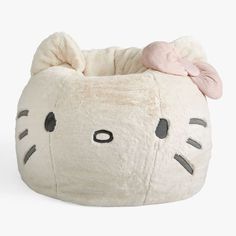 a hello kitty pillow with a bow on it's head is shown in front of a white background