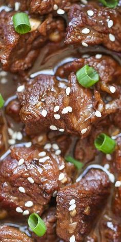 meat with sesame seeds and green onions in a brown sauce