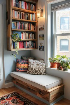 a window seat in front of a book shelf filled with lots of books and plants