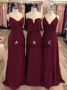 three bridesmaid dresses on mannequins in a store