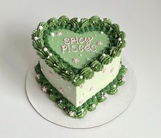 a heart shaped cake with the words spicy pidges written on it