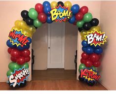 an arch made out of balloons with the word boom written on it in various languages