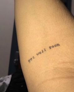 a tattoo saying get well soon on someone's left arm with the words get well soon written in black ink