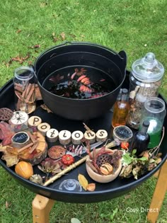 a black tray with various items on it sitting in the grass next to some water